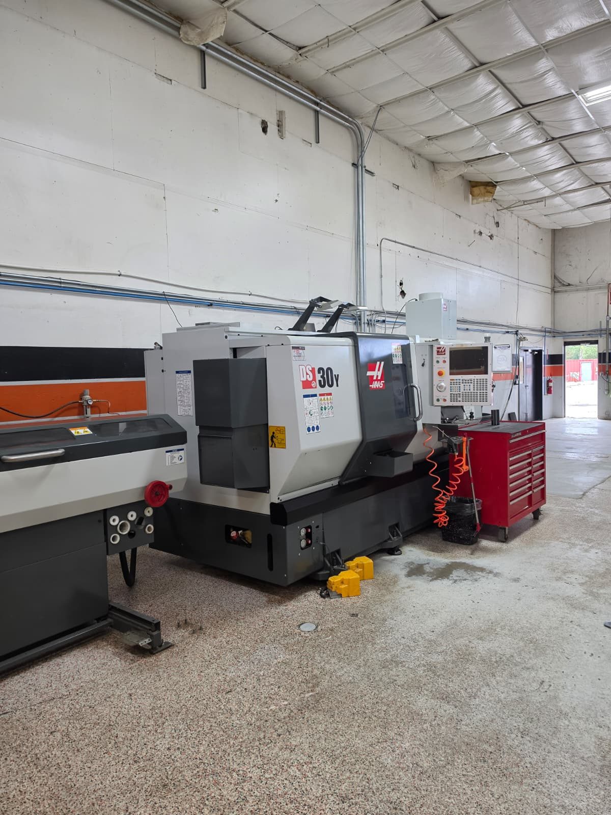 Haas DS-30Y dual-spindle CNC lathe with bar feeder on the shop floor